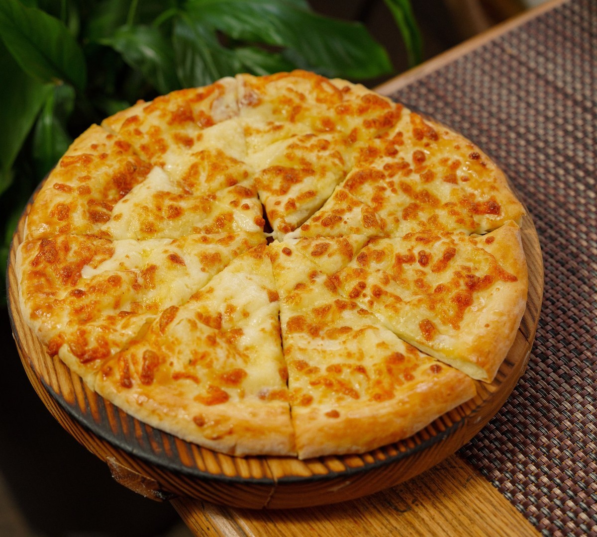 Freshly cut pizza with 8 perfect slices, melted cheese, warm cinematic lighting